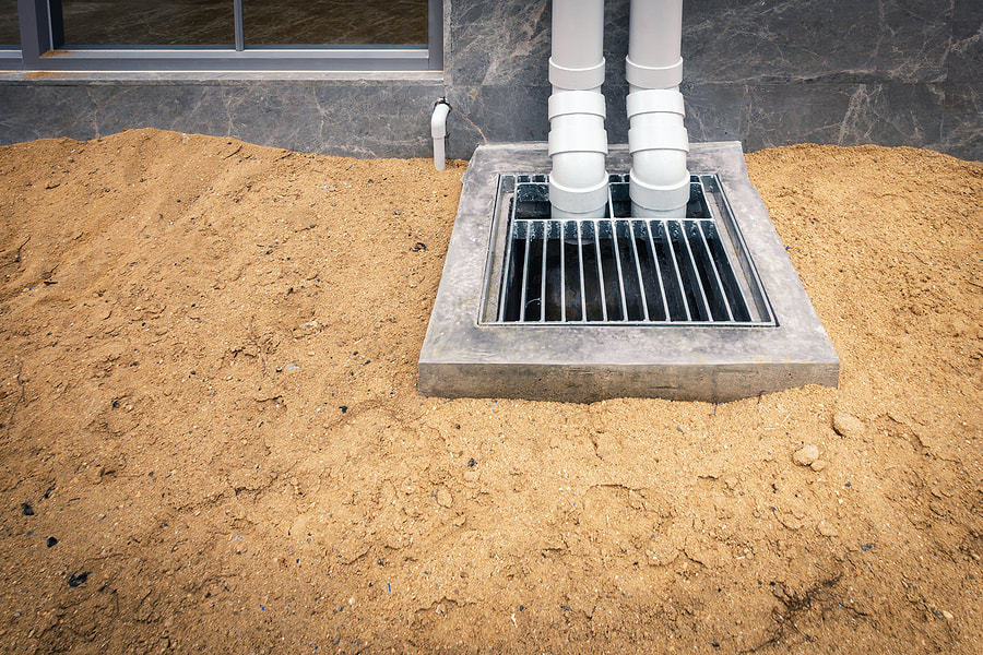 a commercial french drain with two gutter pipe